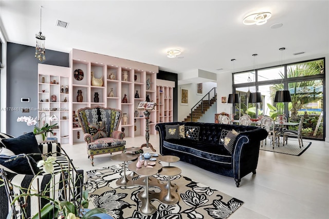 living area featuring stairs and visible vents