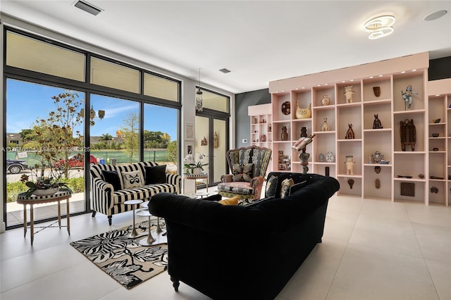 living room featuring light tile patterned floors and visible vents