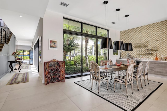 dining room featuring light tile patterned flooring and visible vents