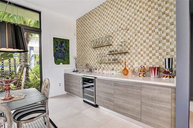 bar featuring bar, a sink, baseboards, wine cooler, and light tile patterned flooring