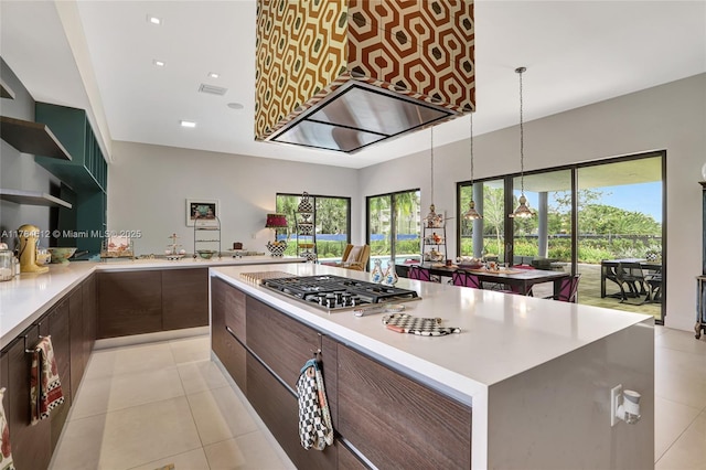 kitchen featuring modern cabinets, open shelves, stainless steel gas cooktop, light countertops, and a wealth of natural light