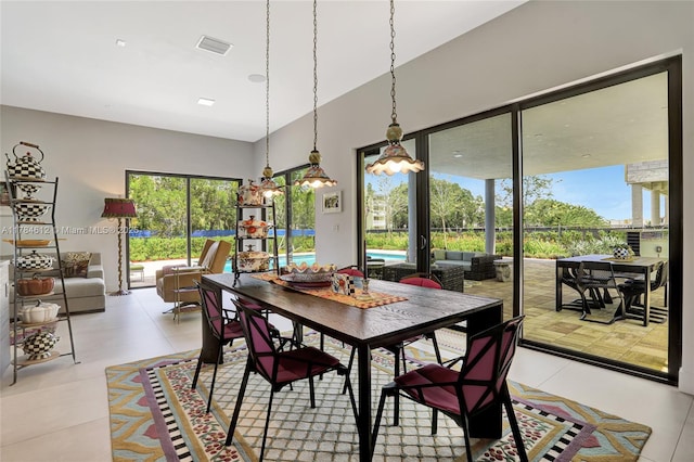 dining space with visible vents and light tile patterned floors