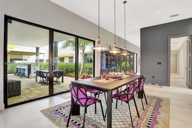 dining area with light tile patterned flooring, a chandelier, and visible vents