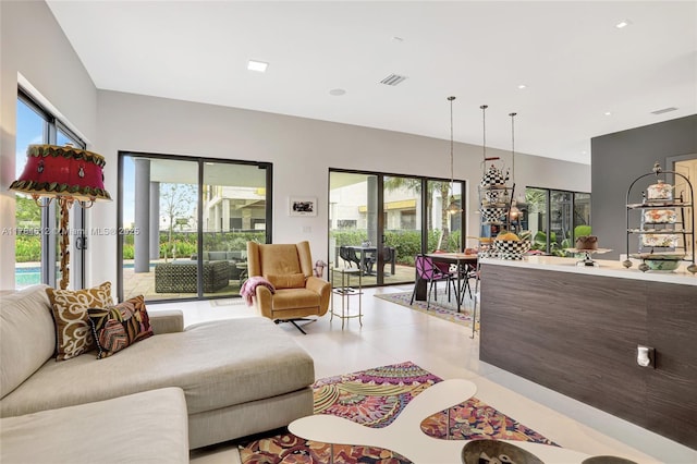 living room with visible vents, light tile patterned floors, and a healthy amount of sunlight