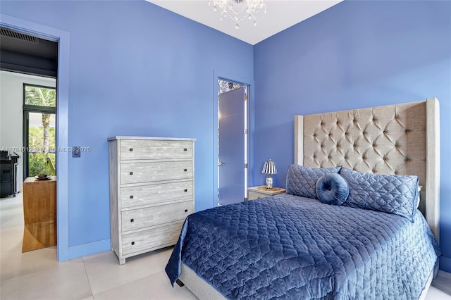 bedroom featuring tile patterned flooring, visible vents, and an inviting chandelier