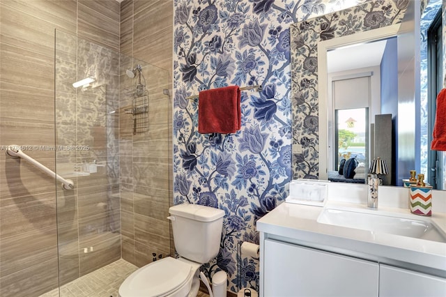 full bath featuring wallpapered walls, a shower stall, and vanity