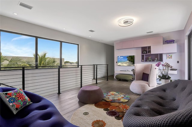living area with wood finished floors and visible vents