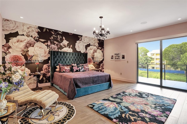 bedroom featuring baseboards, an inviting chandelier, access to exterior, and wood finished floors