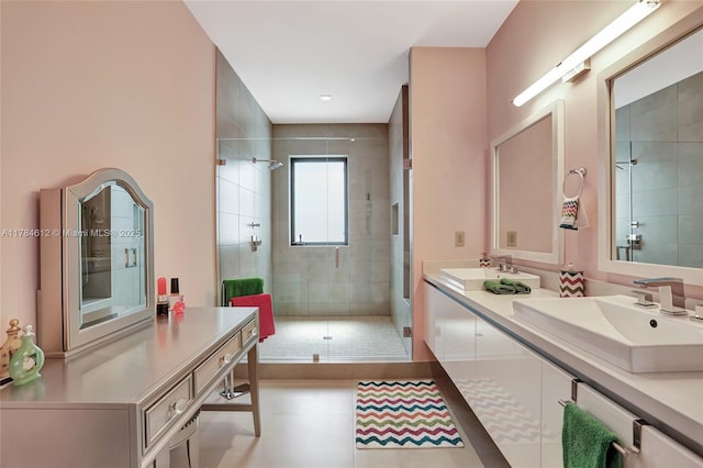 bathroom with a sink, tile patterned floors, a shower stall, and double vanity