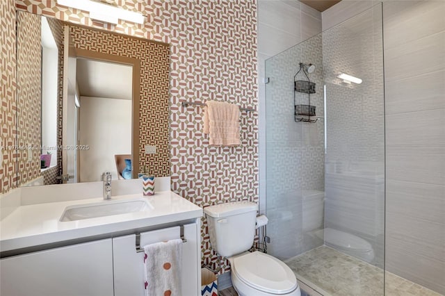 bathroom with vanity, walk in shower, and toilet