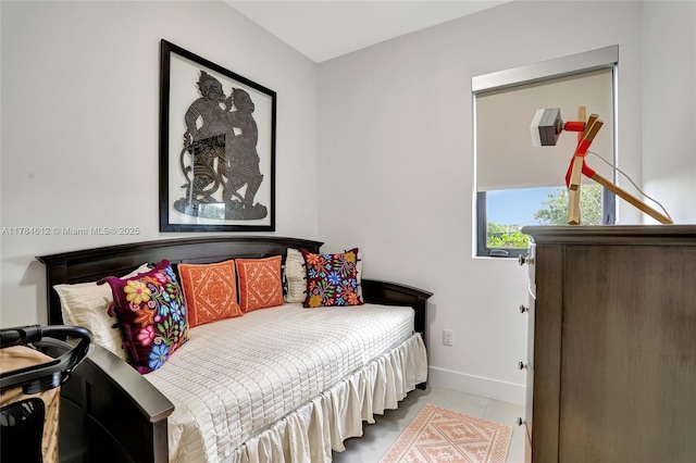 tiled bedroom featuring baseboards
