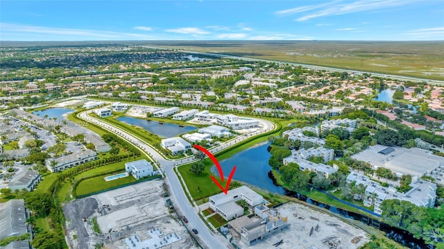 birds eye view of property featuring a water view and a residential view