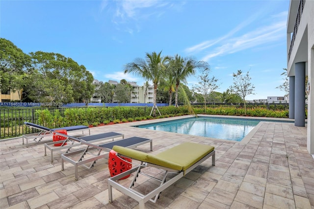 view of swimming pool with a patio, fence, and a fenced in pool
