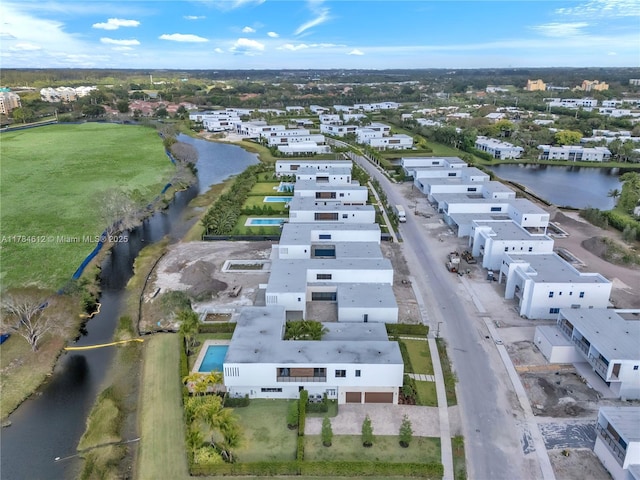 bird's eye view featuring a water view and a residential view