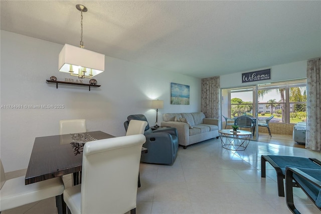 living area with a chandelier and a textured ceiling