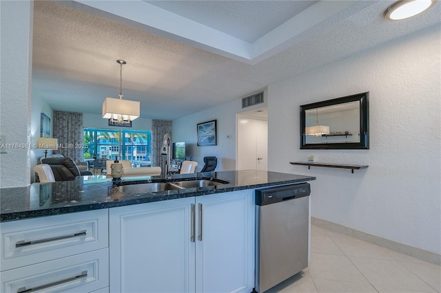 kitchen with a textured ceiling, visible vents, dark stone counters, stainless steel dishwasher, and a sink