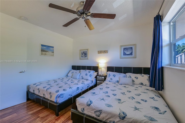 bedroom featuring a ceiling fan and wood finished floors