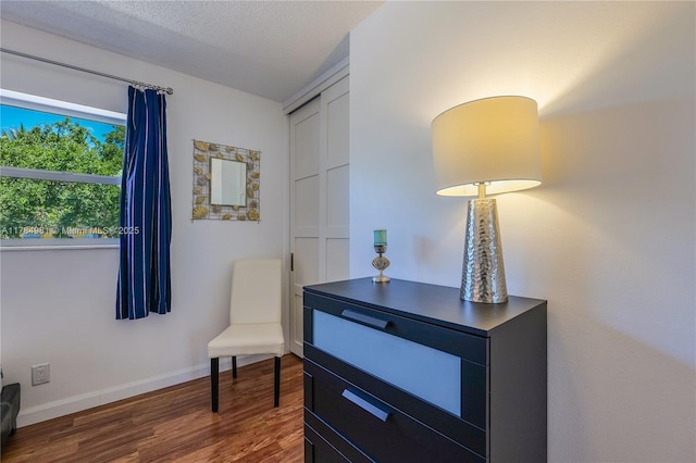 living area featuring wood finished floors and baseboards