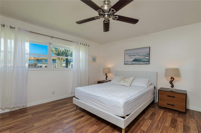 bedroom featuring baseboards, a ceiling fan, and wood finished floors