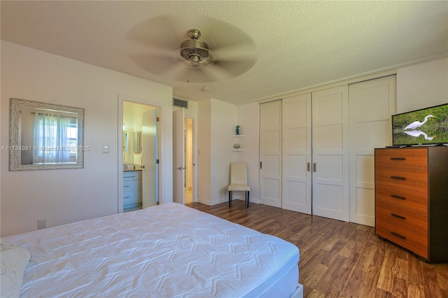bedroom with wood finished floors, a closet, a ceiling fan, and visible vents