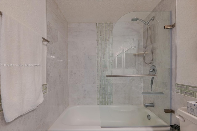 bathroom featuring bathtub / shower combination, tile walls, a textured ceiling, and toilet