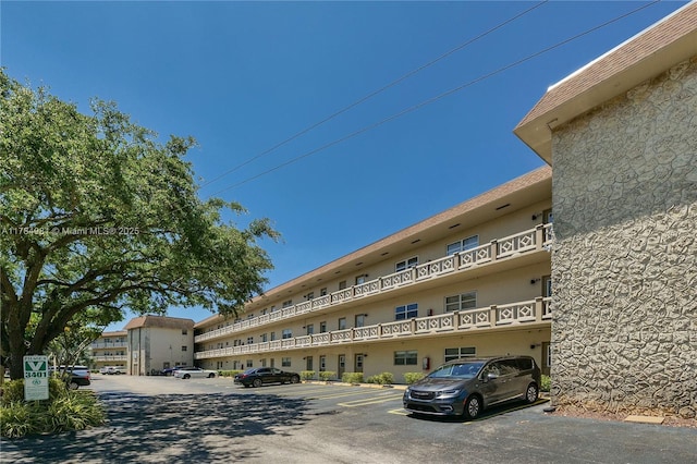 view of building exterior with uncovered parking