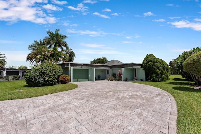 5721 Bayberry Ln, Tamarac, FL 33319 - view of front of property with decorative driveway, an attached garage, and a front yard