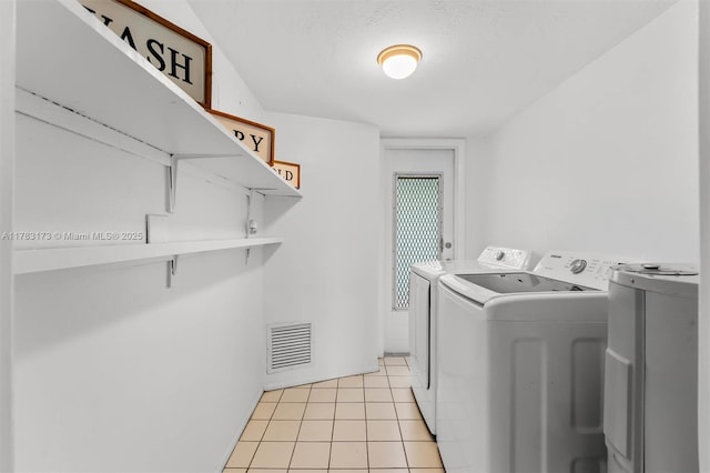 5721 Bayberry Ln, Tamarac, FL 33319 - laundry area with washing machine and dryer and light tile patterned floors