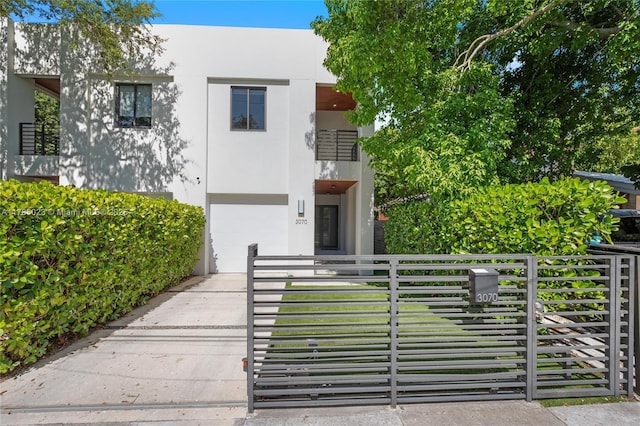 3070 Elizabeth St Unit 3070, Coconut Grove, FL 33133 - view of front of house featuring a gate, stucco siding, and a fenced front yard