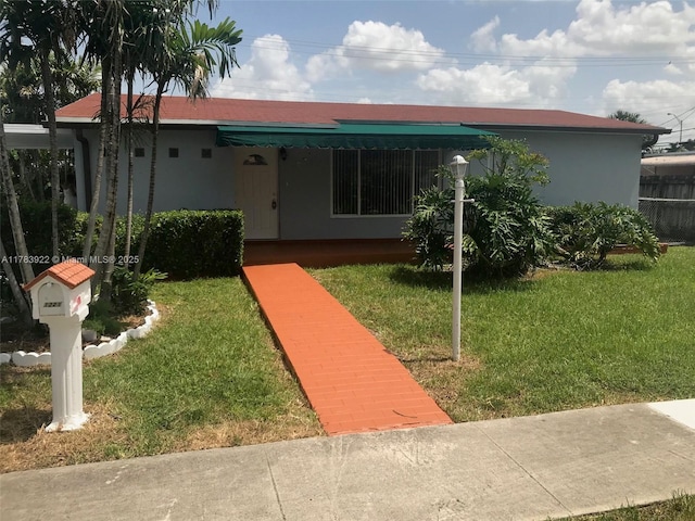 1221 W 62nd St, Hialeah, FL 33012 - view of front of house featuring stucco siding and a front lawn