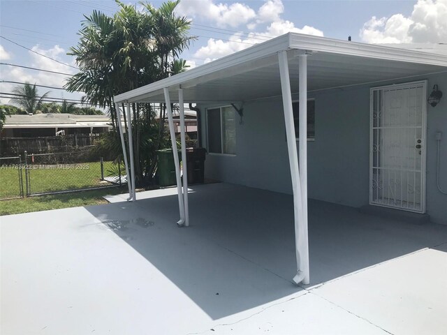 1221 W 62nd St, Hialeah, FL 33012 - view of patio / terrace with a carport and fence