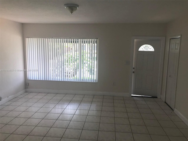 1221 W 62nd St, Hialeah, FL 33012 - entrance foyer featuring a wealth of natural light, light tile patterned flooring, and baseboards