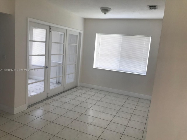 1221 W 62nd St, Hialeah, FL 33012 - unfurnished room featuring french doors, light tile patterned floors, baseboards, and visible vents