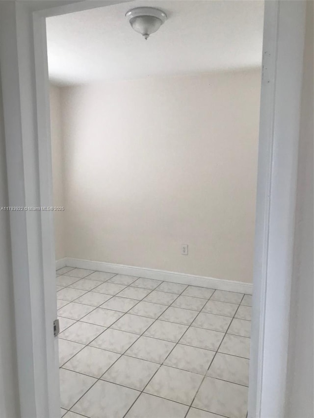 1221 W 62nd St, Hialeah, FL 33012 - unfurnished room featuring light tile patterned floors and baseboards
