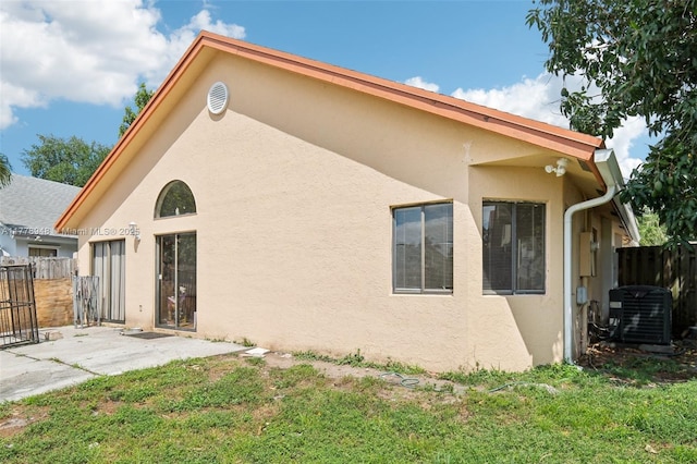 711 Holly St, North Lauderdale, FL 33068 - back of house with a yard, fence, cooling unit, a patio, and stucco siding