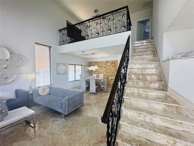 stairs featuring visible vents and a high ceiling
