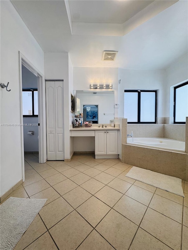 full bath featuring a bath, tile patterned floors, vanity, and visible vents