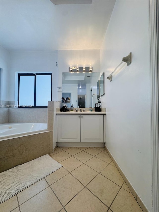 bathroom with a bath, tile patterned flooring, and vanity
