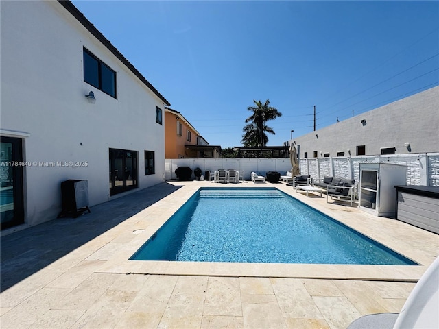view of swimming pool featuring a fenced in pool, a patio, and fence