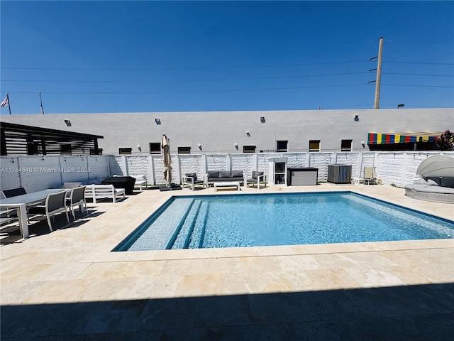 view of swimming pool featuring a fenced in pool, a patio, and central AC