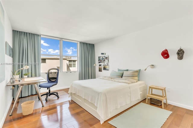 9250 W Bay Harbor Dr Unit 5C, Bay Harbor Islands, FL 33154 - bedroom featuring baseboards and wood finished floors