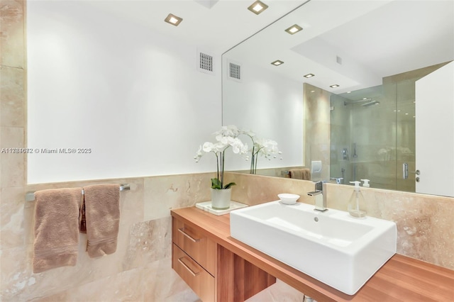 9250 W Bay Harbor Dr Unit 5C, Bay Harbor Islands, FL 33154 - bathroom with vanity, visible vents, tile walls, and a stall shower