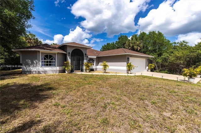 2661 SE 30th Ave, Naples, FL 34117 - mediterranean / spanish-style home featuring driveway, a front lawn, a garage, and stucco siding