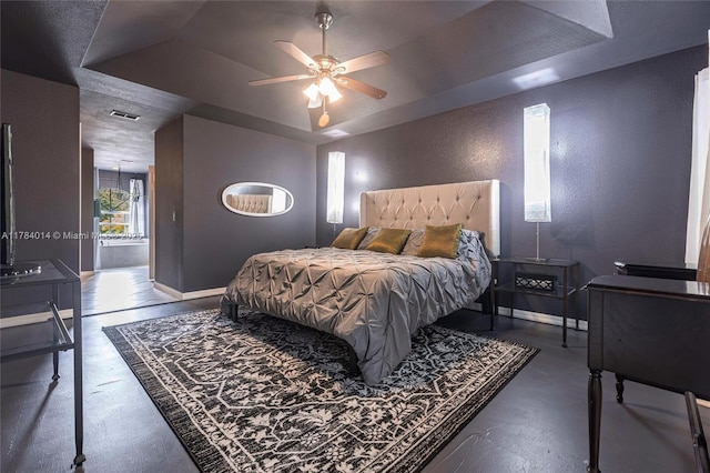 2661 SE 30th Ave, Naples, FL 34117 - bedroom featuring concrete floors, baseboards, a textured wall, visible vents, and a tray ceiling