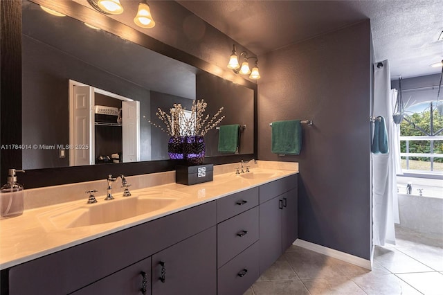 2661 SE 30th Ave, Naples, FL 34117 - bathroom with a sink, tile patterned floors, double vanity, and a textured ceiling