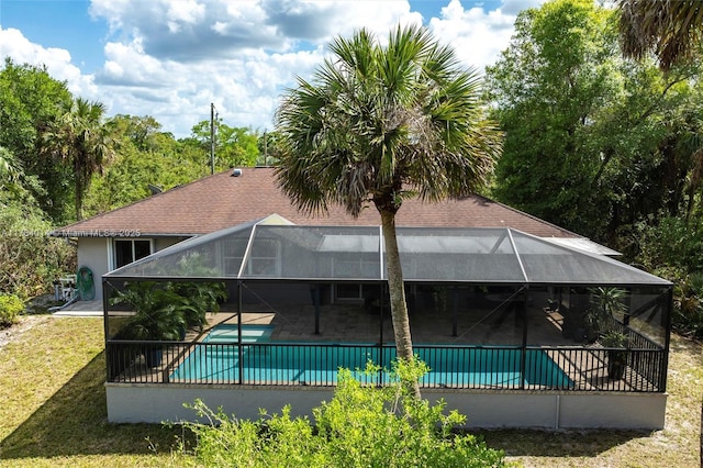2661 SE 30th Ave, Naples, FL 34117 - back of house with a patio area, a lawn, glass enclosure, stucco siding, and a fenced in pool