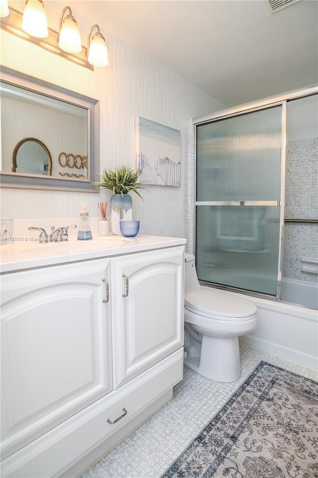 581 Blue Heron Dr Unit 112-B, Hallandale Beach, FL 33009 - bathroom featuring shower / bath combination with glass door, vanity, visible vents, toilet, and tile patterned floors