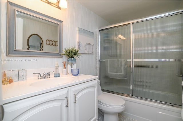 581 Blue Heron Dr Unit 112-B, Hallandale Beach, FL 33009 - bathroom with combined bath / shower with glass door, vanity, and toilet