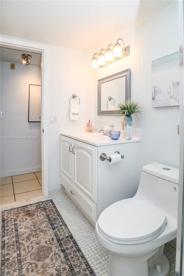 581 Blue Heron Dr Unit 112-B, Hallandale Beach, FL 33009 - bathroom featuring tile patterned flooring, vanity, baseboards, and toilet