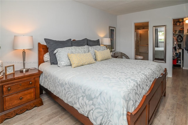 581 Blue Heron Dr Unit 112-B, Hallandale Beach, FL 33009 - bedroom with a closet, light wood finished floors, a spacious closet, and connected bathroom